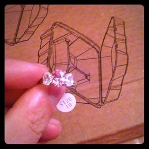silver-colored clear and pink faceted gemstone
